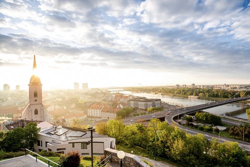 Blick auf Bratislava bei Sonnenaufgang mit der Brücke des Slowakischen Nationalaufstandes und dem UFO Tower über der Donau .